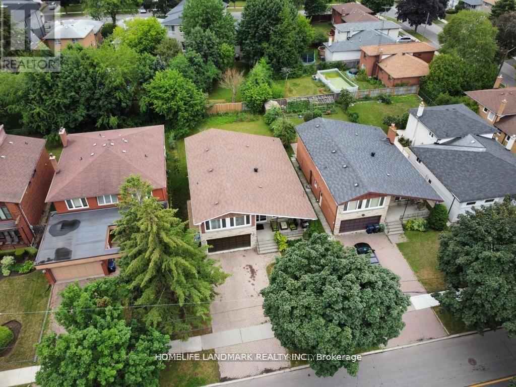 A bird's eye view of a residential neighborhood with houses and trees.