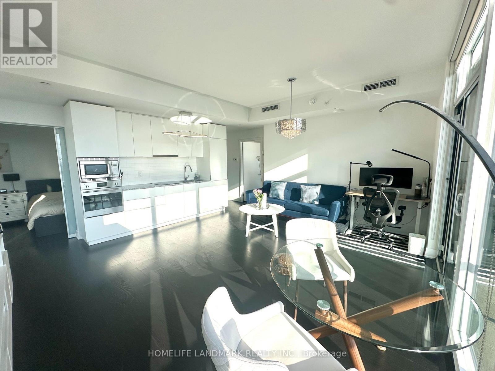 A modern kitchen with a glass table and chairs.