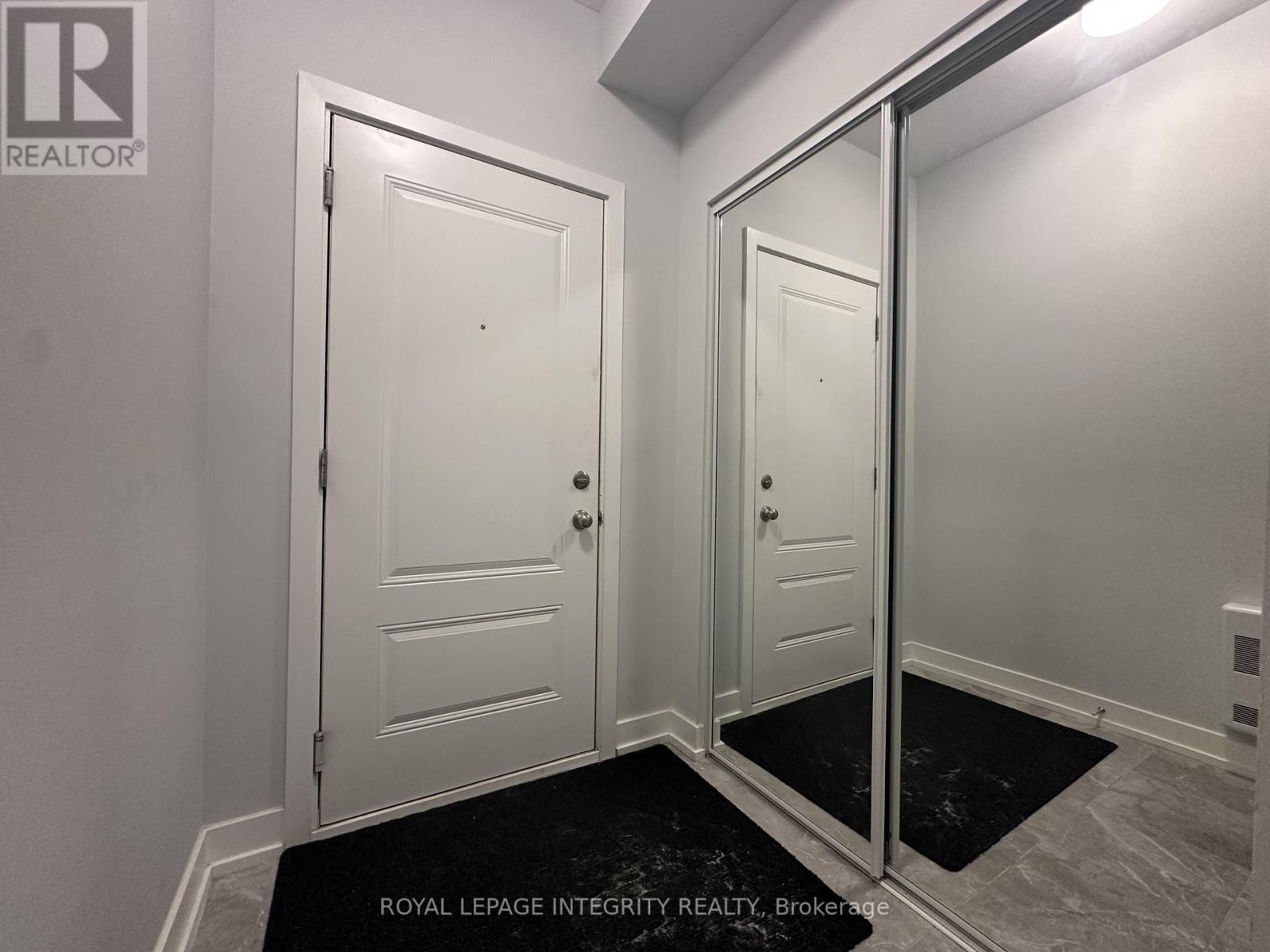 A white door is on the left and a mirrored door is on the right.