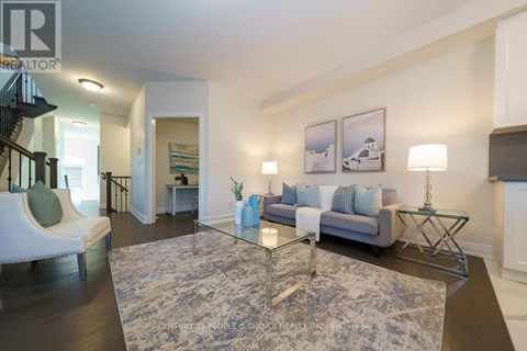 A living room with a grey sofa and a glass coffee table.