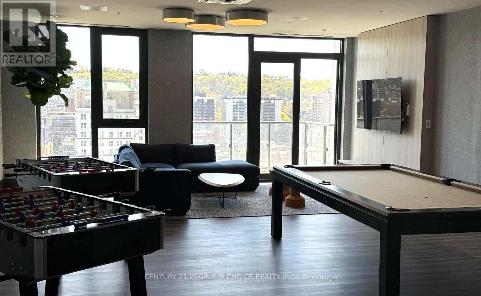 A room with a pool table and a foosball table.