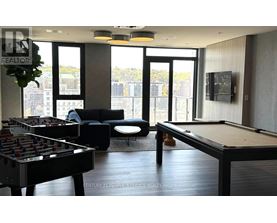 A room with a pool table and a foosball table.