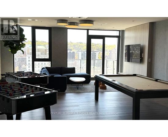 A room with a pool table and a foosball table.