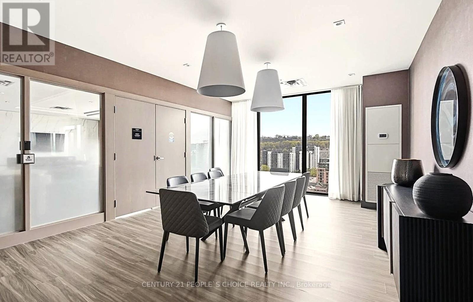 A modern dining room with a glass table and chairs.