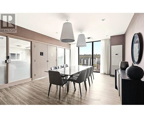 A modern dining room with a glass table and chairs.