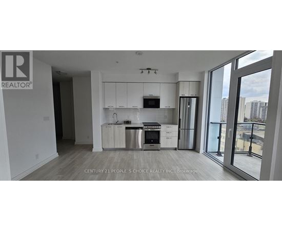 A modern kitchen with white cabinets and stainless steel appliances.