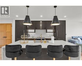 A modern kitchen with a dining table and chairs.