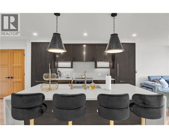 A modern kitchen with a dining table and chairs.