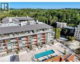 A large apartment complex with a pool in the middle of a courtyard.