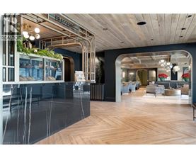 A modern interior space with a wooden floor and a glass wall.