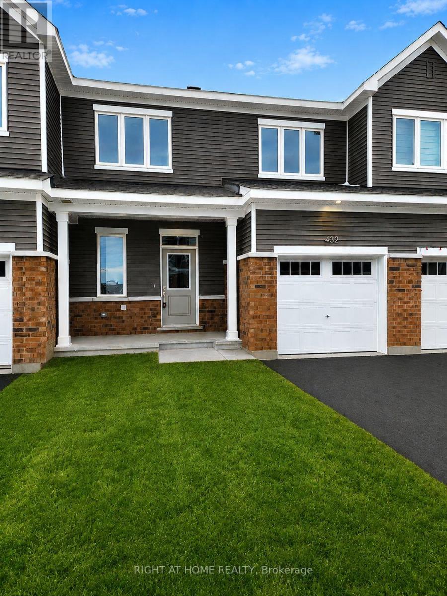 A house with a grey exterior and a white garage door.