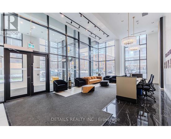 A modern office space with black and white decor and a view of the city.