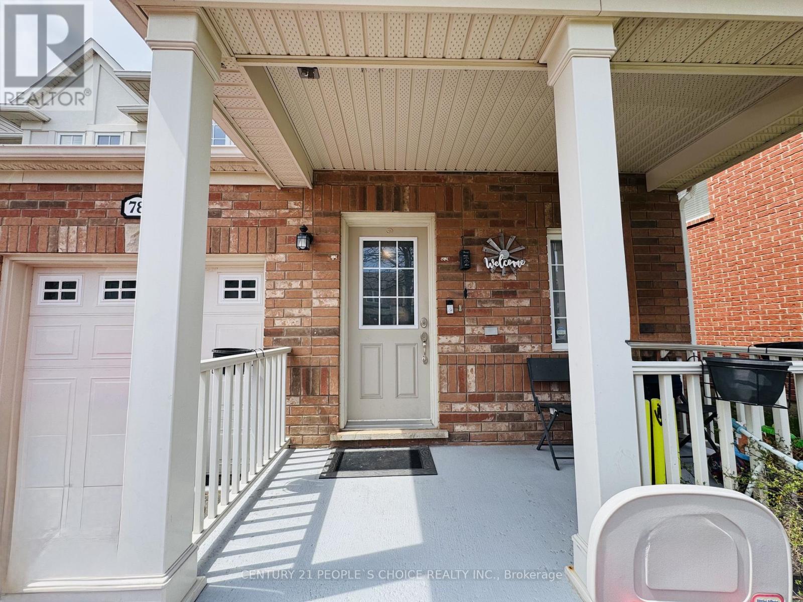 A house with a white door and a porch with a white railing.