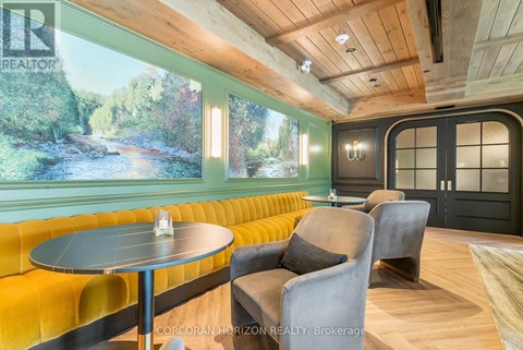A living room with a yellow couch and a round table.