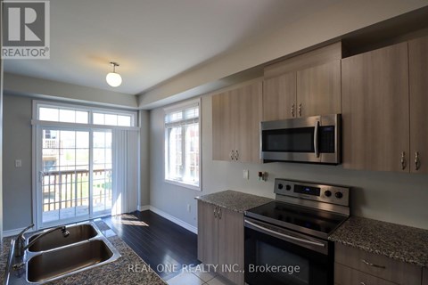 A kitchen with a stove top oven and microwave.