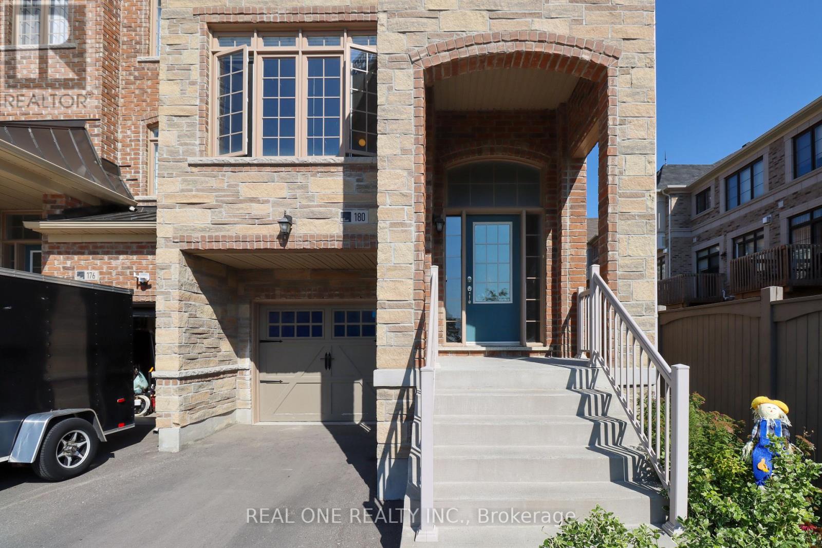 A house with a stone facade and a blue door is for sale.