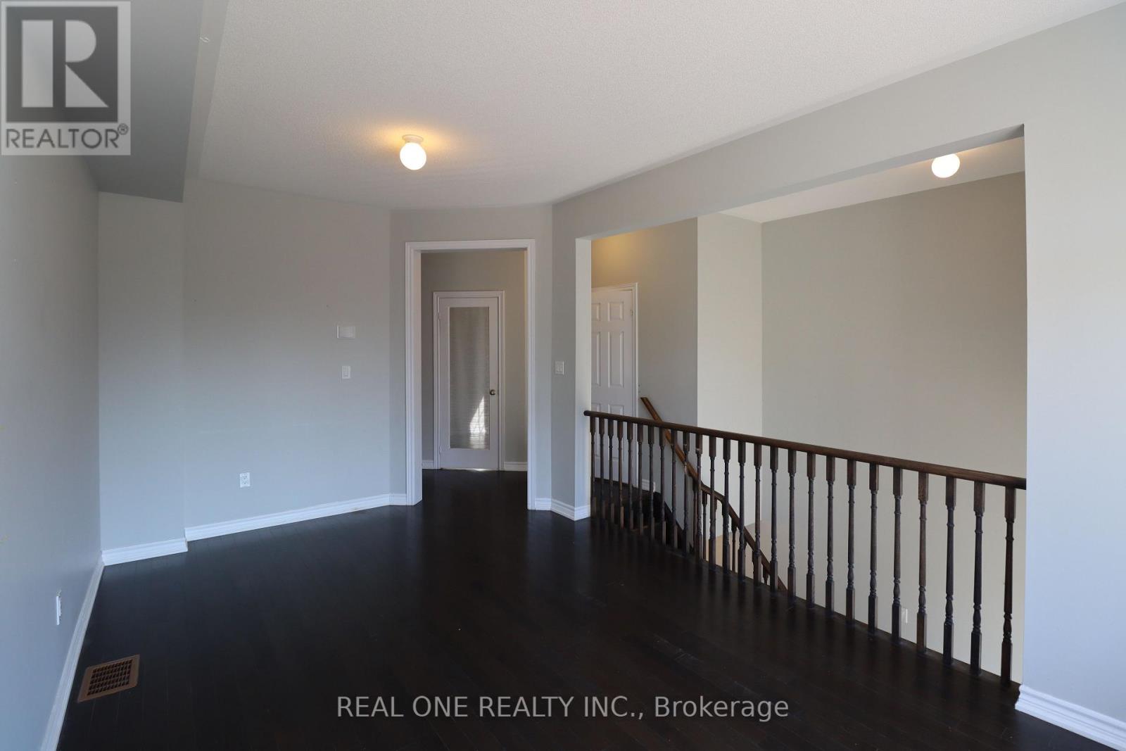 A hallway with a staircase leading to the second floor.