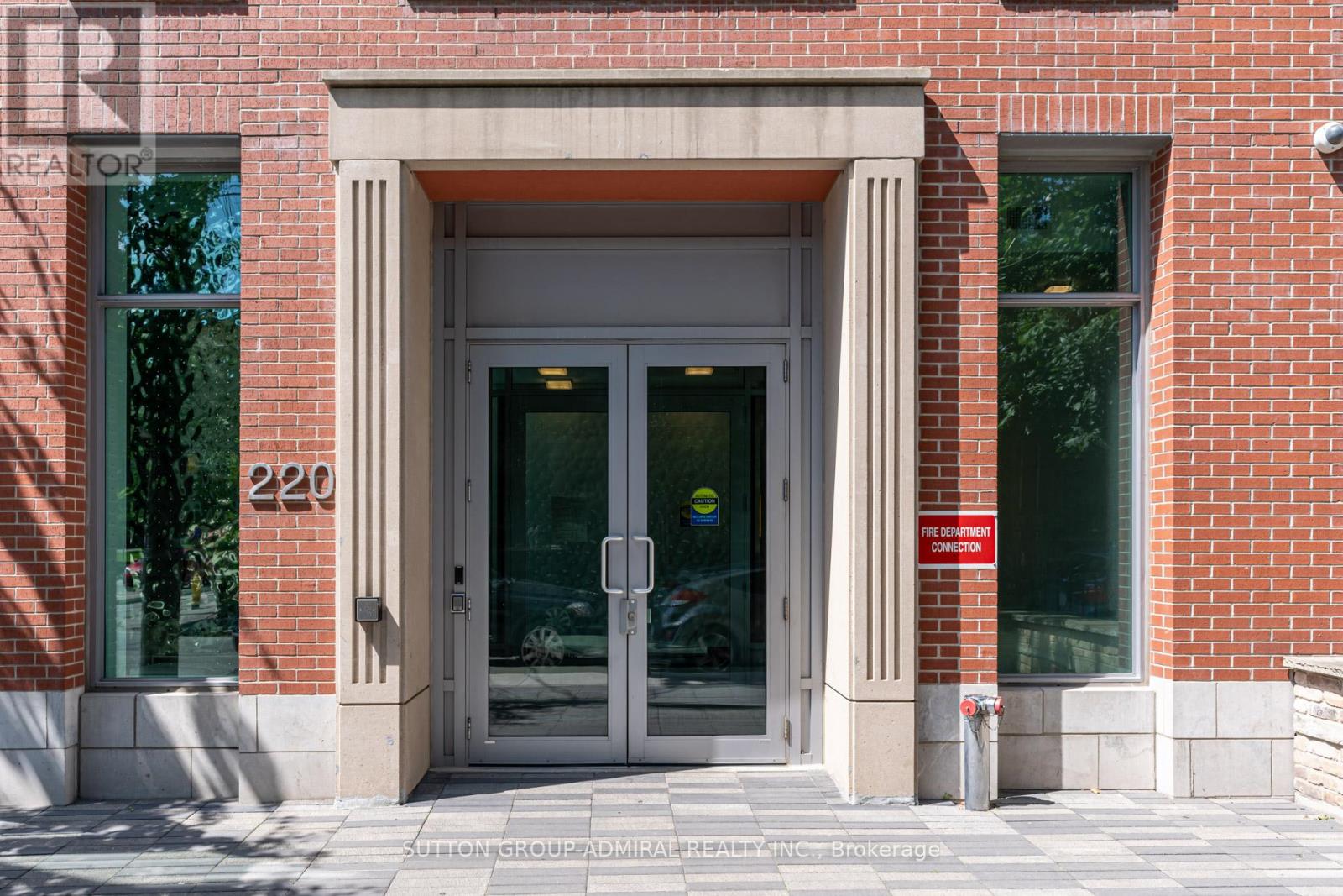 The front of a building with a glass door and a sign that says "No Parking".