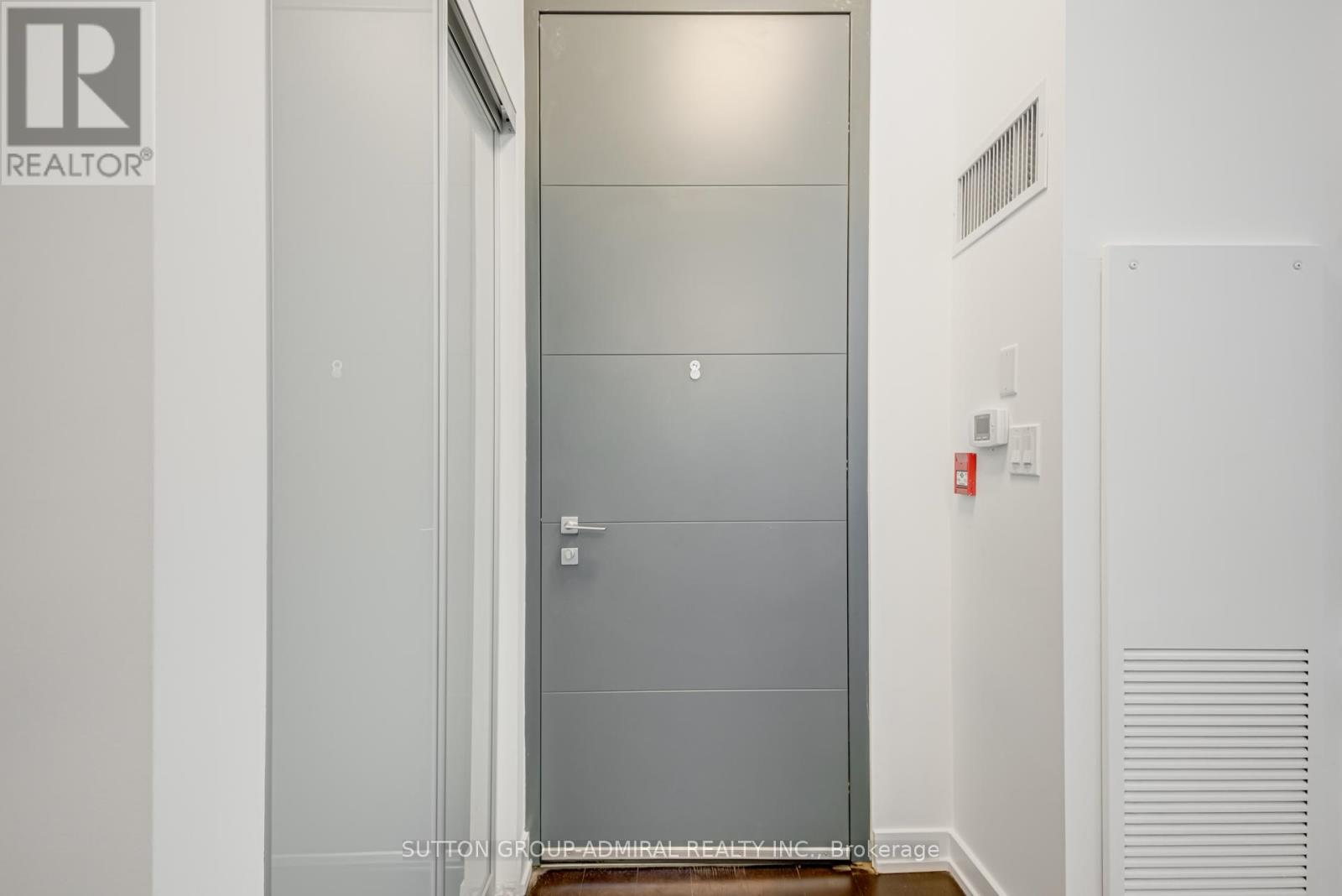 A white door with a glass panel is in the middle of a room.