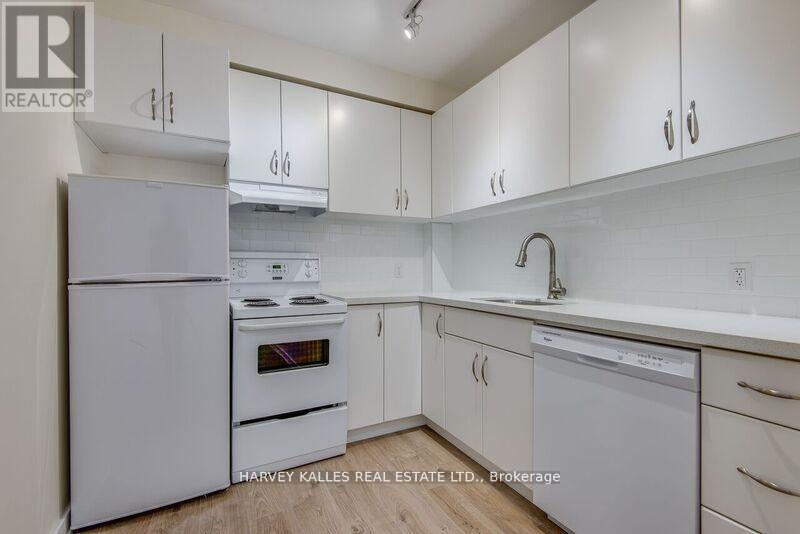 A kitchen with white appliances and cabinets.