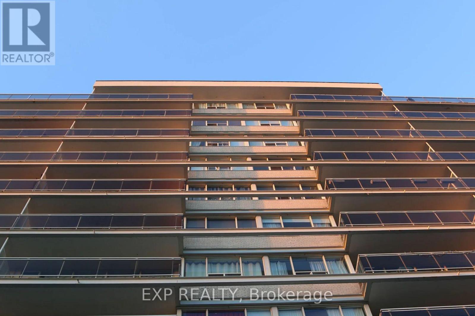A tall building with the words EXP REALTY Brokerage on the bottom.