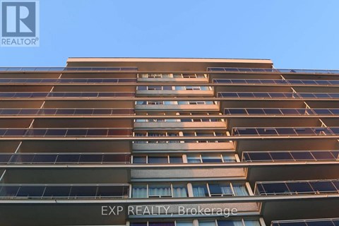 A tall building with the words EXP REALTY Brokerage on the bottom.