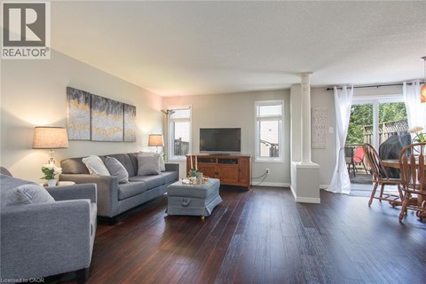 A living room with a grey couch and a wooden coffee table.