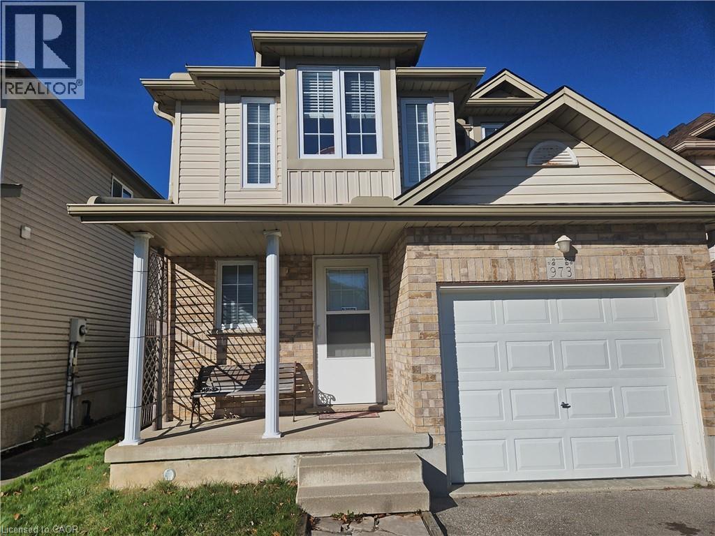 A house with a garage door and a porch.