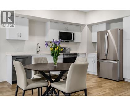 A modern kitchen with a table and chairs.