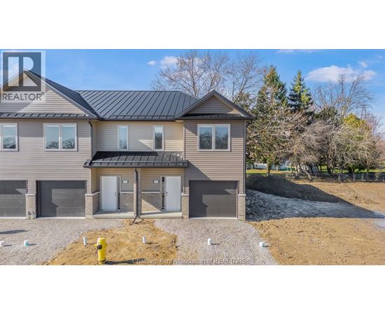 A house with a grey roof and a sign that says REALTOR on the left side.