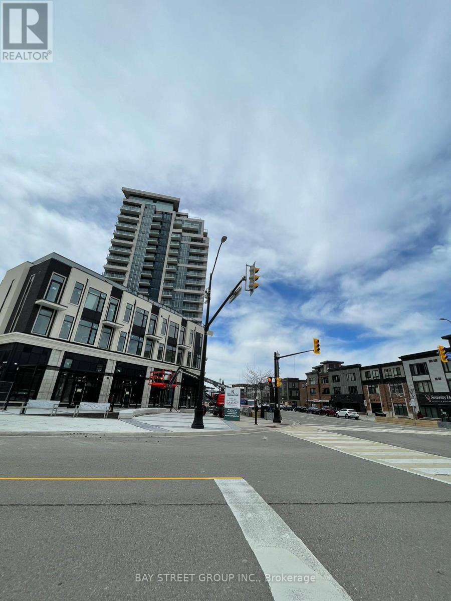 A street view of a city with a building in the background and a sign that says "BAY STREET GROUP, INC. BROKERAGE".