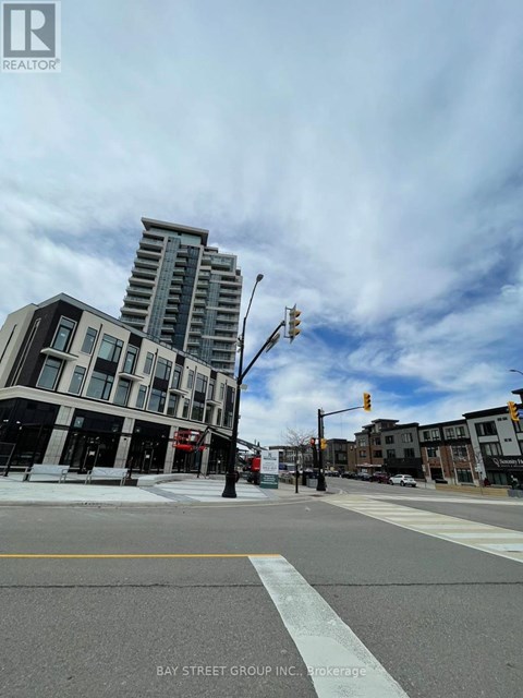 A street view of a city with a building in the background and a sign that says "BAY STREET GROUP, INC. BROKERAGE".