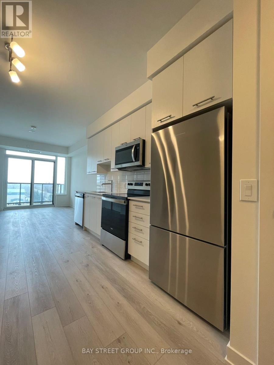 A modern kitchen with a stainless steel refrigerator.