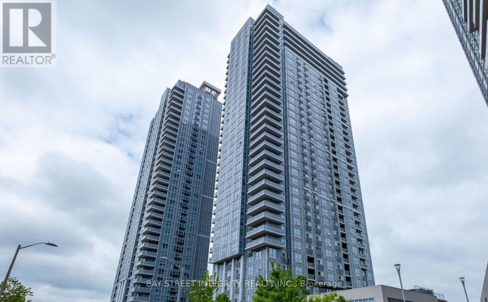 Two tall buildings with windows are seen in the image.