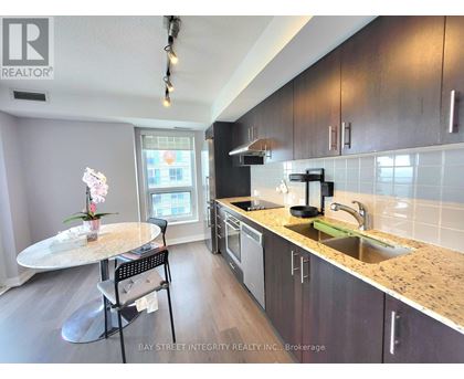 A kitchen with a table and chairs in front of a window.