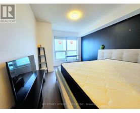 A bedroom with a large bed and a flat screen TV.