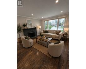 A well-lit living room with a fireplace and comfortable seating.
