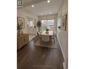 A dining room with a table set for four.