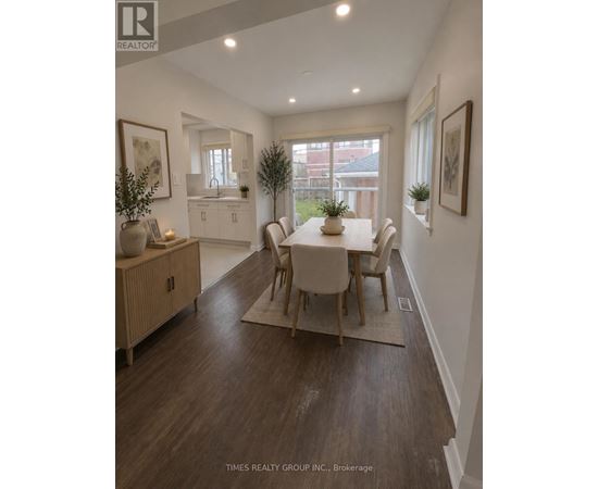 A dining room with a table set for four.
