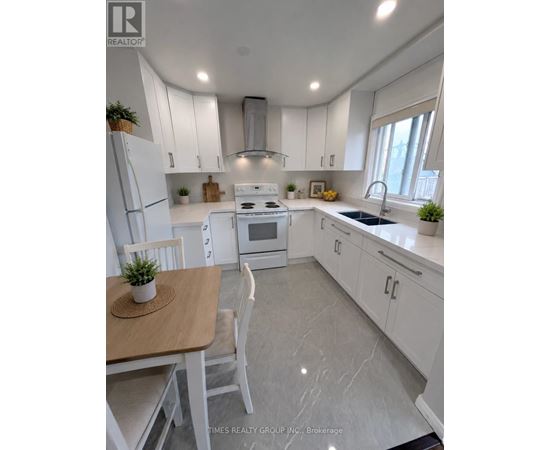 A white kitchen with a table and chairs.