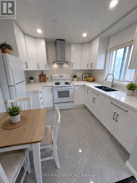 A white kitchen with a table and chairs.