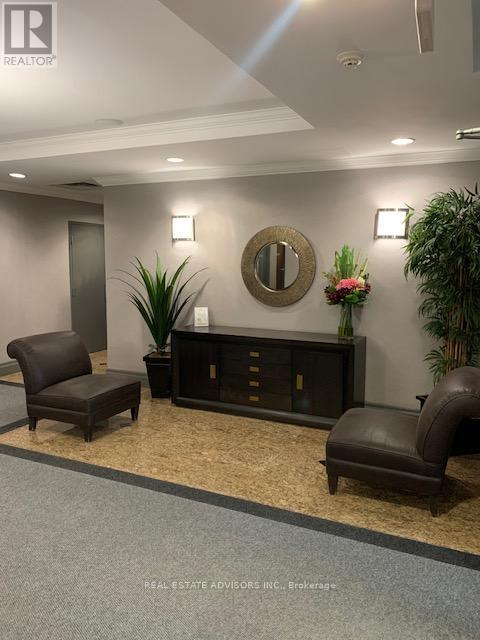A real estate office with a brown leather chair and a wooden cabinet.