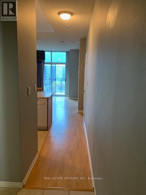 A long hallway with a Real Estate Advisors Inc. sign on the bottom.