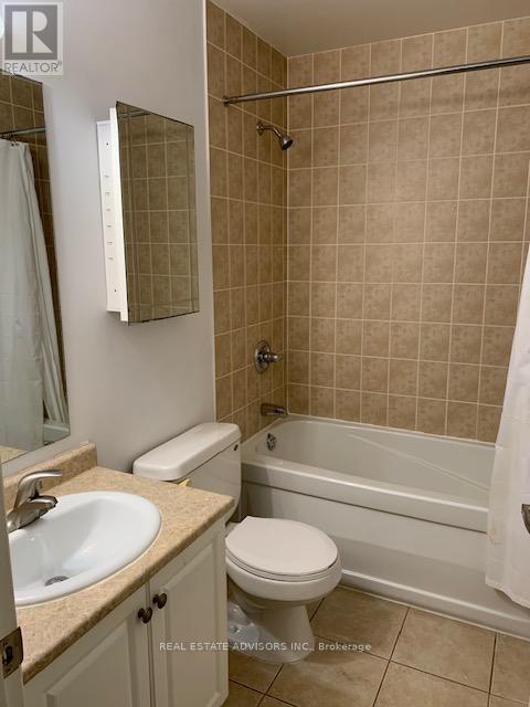 A bathroom with a toilet, sink, and bathtub.