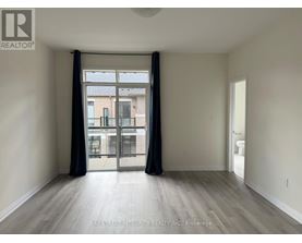 A spacious room with a view of a building through the window.