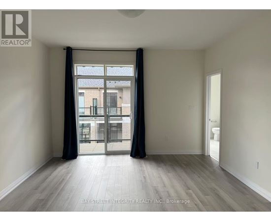 A spacious room with a view of a building through the window.