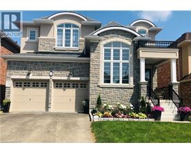A large house with a stone facade and a garage.