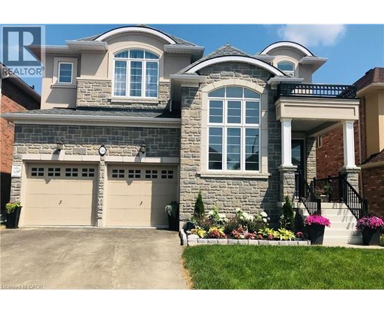 A large house with a stone facade and a garage.