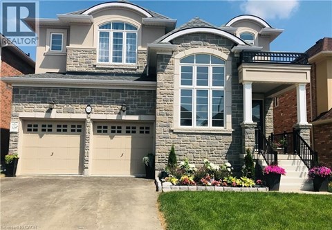 A large house with a stone facade and a garage.