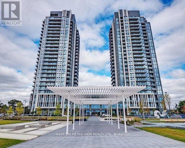 Two tall buildings with a canopy in front of them.